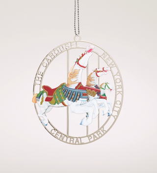 Central Park Carousel ornament featuring two carousel horses in a circular frame with the text 'The Carousel New York City Central Park.'