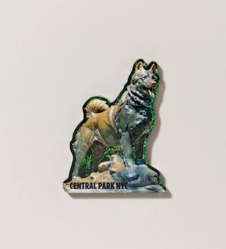 a shaped acrylic magnet featuring a photograph of a statue of a dog