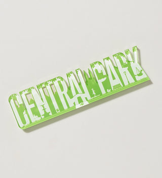 Green 'Central Park' magnet with cut-out designs, displayed at an angle on a flat surface.