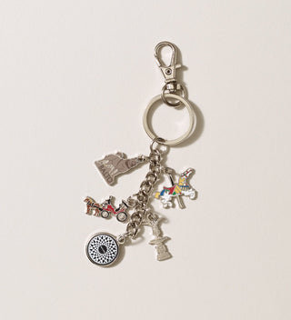 Central Park Conservancy charm keychain out of its packaging, showing various charms including a carousel horse, Balto, Imagine, and more