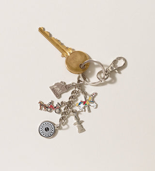 Central Park Conservancy charm keychain with attached keys, featuring charms including a carousel horse, and Balto