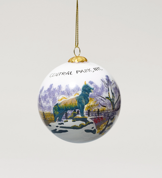 Central Park-themed hanging ornament featuring a dog standing on a rock in a winter landscape.