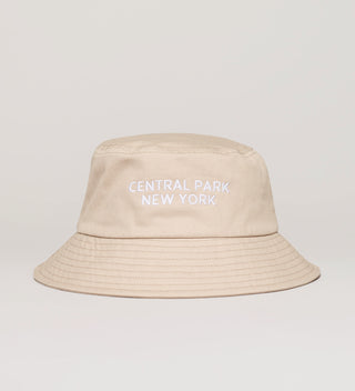 Beige bucket hat with "Central Park New York" embroidered in white
