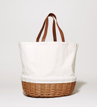 White picnic bag, with a bottom that resembles a picnic basket and leather handles