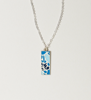 Central Park Conservancy necklace with a blue leaf design, displayed on a light grey background