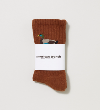 Packaged American Trench brown socks with a duck on them