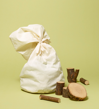 Packaged barked wooden blocks for children, some blocks shown outside of the bag