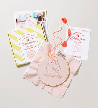 Cotton Clara bird embroidery kit packaging with embroidery hoop, needle, and embroidery floss displayed