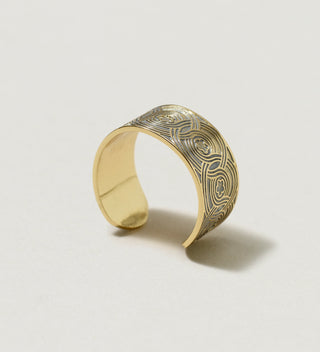 Close-up of small Central Park Conservancy ring with intricate circular patterns and floral motifs, standing up