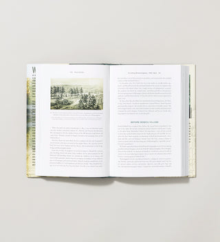 an open book with text about Seneca Village in Central Park and an engraved image of the view from Summit Rock in Central Park