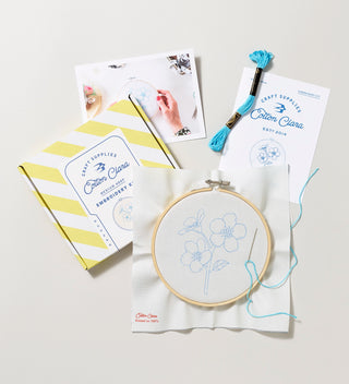 Cotton Clara flowers embroidery kit packaging with embroidery hoop, needle, and embroidery floss displayed