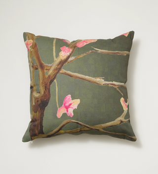 India & Purry square pillow with a design of Eastern Redbud in blossoms on a dark green background.