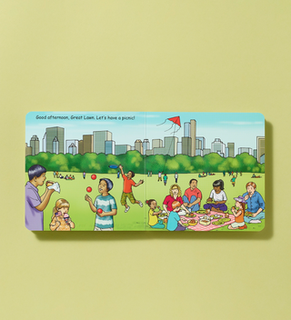 Illustrated book spread showing families having a picnic and playing on the Great Lawn in Central Park.