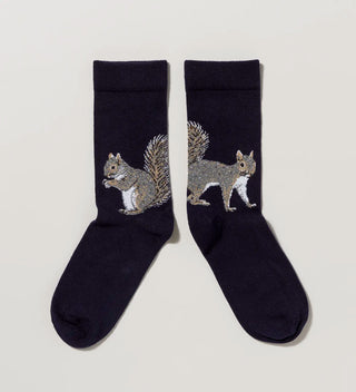 a pair of navy socks featuring  two distinct squirrel designs