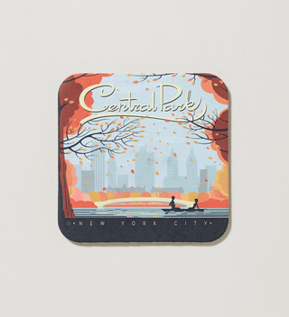 Central Park-themed coaster featuring an autumn scene with falling leaves and the city skyline in the background.