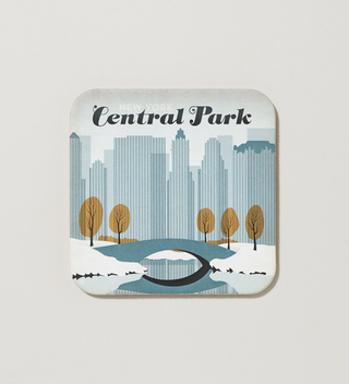 Central Park-themed coaster featuring a snowy scene with a bridge and the city skyline in the background.