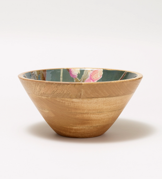 Side view of wooden bowl with a painted flower and branch pattern on the inside