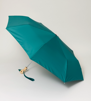 Opened Emerald green umbrella with a handle that's shaped to look like a duck