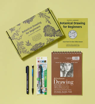 Opened botanical drawing kit for beginners, featuring a sketch pad, mechanical pencil and pens, and a QR code that links to a video lesson