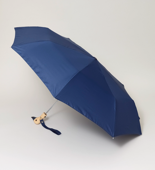 Opened navy umbrella with a handle that's shaped to look like a duck