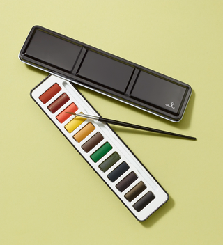 Watercolor set, with the watercolor brush leaning against the case