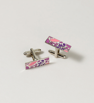 Pair of Central Park Conservancy cufflinks with a purple and pink leaf design, displayed on a light grey background