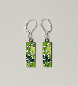 Close-up of green leaf design pendant earrings with lever-back hooks