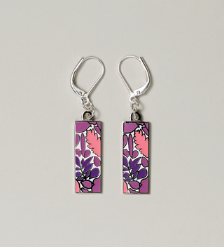 Close-up of pink and purple leaf design pendant earrings with lever-back hooks