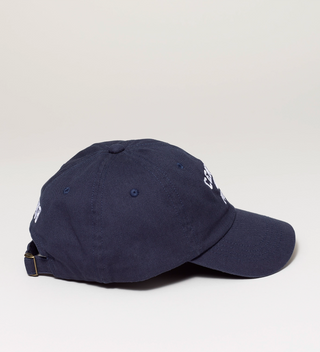 Side view of a navy blue baseball cap with white embroidered text 'Central Park NYC' and an adjustable strap.