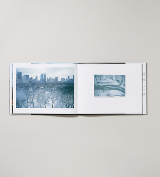 "Windows on Central Park: The Landscape Revealed" book opened to showcase two captioned winter photographs