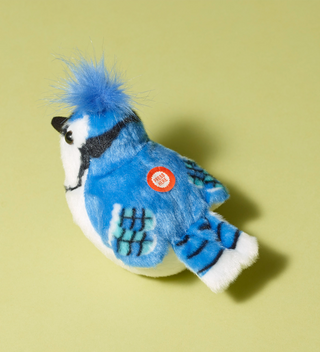 Audubon plush toy, Blue jay bird with blue and white colors, featuring a button labeled 'Press Here' on its back to hear an authentic bird call from the Cornell Lab of Ornithology's wildlife recordings