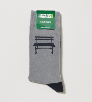 Folded pair of gray and black adult socks with a Central Park bench and the Central Park Conservancy logo on them