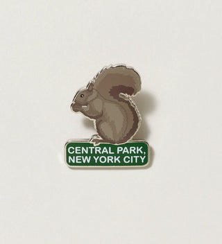 Close-up of a squirrel-shaped pin with 'Central Park, New York City' text on a white background.