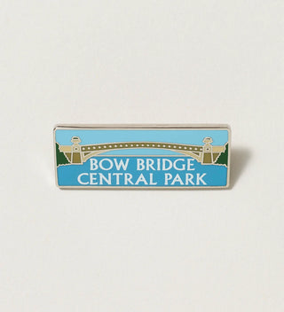 Close-up of a rectangular pin with 'Bow Bridge Central Park' text and an illustration of Bow Bridge, on a white background.