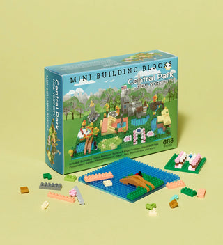 Mini building blocks kit for Central Park, New York City, with box and partially assembled model pieces displayed.