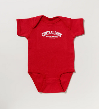 Red baby onesie with Central Park New York City since 1858 on a grey background