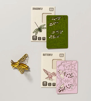 three  wooden models of a bee, butterfly and dragonfly, two flat with their packaging and one constructed bee