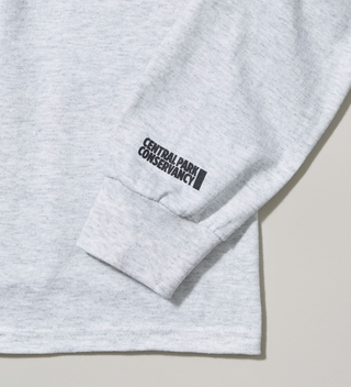 Close-up of the Central Park Conservancy logo on the sleeve of a grey long sleeved shirt