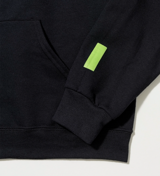 Close-up of the Central Park Conservancy logo on the sleeve of a black "Central Park" hoodie