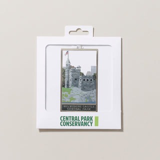 Decorative ornament with a castle design and the text "Belvedere Castle Central Park" in a white envelope with a clear window on a gray background.