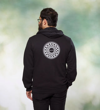 Man wearing a black hoodie with "Imagine" mosaic design on the back