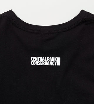 Back of a black t-shirt with 'Central Park Conservancy' text near the neck.