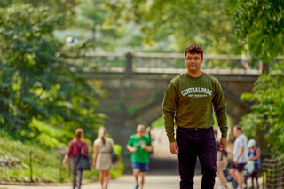 Man wearing Central Park collegiate sweatshirt in Central Park