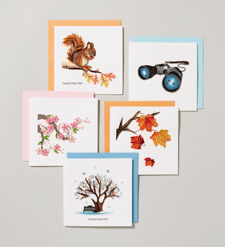 a group of handmade card featuring natural vignettes including a squirrel, autumn leaves, cherry tree blossoms and a winter scene.