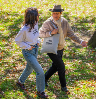 Two women walking through Central Park wearing items from the Bench Design Collection sold at the Central Park Conservancy shop.