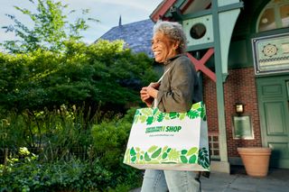 Picture of a woman exciting the Dana Gift Shop and Visitor center located in the north end of Central Park and run by the Central Park Conservancy 