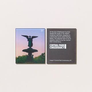 An acrylic magnet featuring a photograph of Bethesda Fountain in Central Park with its reverse featuring text and a logo on a gray background.