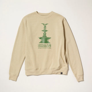 Beige sweatshirt with green graphic of Bethesda Fountain in Central Park and text on a gray background