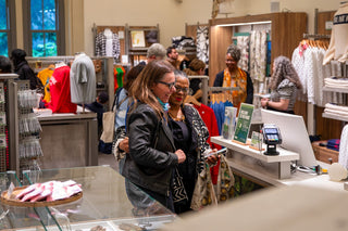 a group of people celebrate while shopping