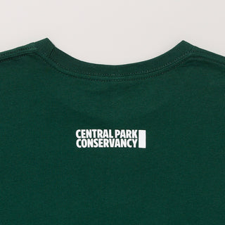 Forest green t-shirt with 'Central Park Conservancy' logo on a light gray background